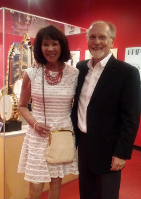 Tim and his wife Nida at the Banjo Hall of Fame in front of a display case